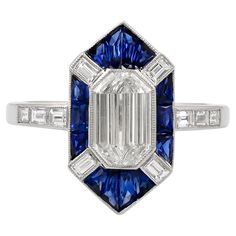 This Art Deco inspired platinum ring by Sophia D. features a 1.00 carat center diamond accentuated with .70 carat of blue sapphire and 0.32 carat small diamonds. Available for resizing. Sophia D by Joseph Dardashti LTD has been known worldwide for 35 years and are inspired by classic Art Deco design that merges with modern manufacturing techniques.