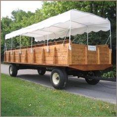 an old truck with wooden crates on the back and canopy over it's bed