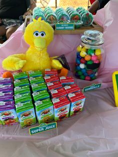 a table with candy and stuffed animals on it