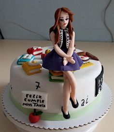 a cake with a woman sitting on top of it