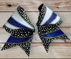 Super cute Cheer Bow is made with 3" Black/Royal/White Glitter on Black Ribbon with AB Rhinestone Bling Design and  Wrapped Center. Cheer Bow measures approximately 6" wide and 6 1/2" long. Cheer Bow is attached to a cotton seamless band. If you would like a different color or need to order more than one, please send me a message with your request. All bows are heat sealed to prevent fraying and come from a smoke free home. Cute Cheer Bows, Cheer Hair Bows, Bow Ideas, Cheer Hair, Bling Design, Cheer Bow, Cheer Bows, White Glitter, Black Ribbon