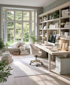 a home office with lots of bookshelves and desks in front of large windows