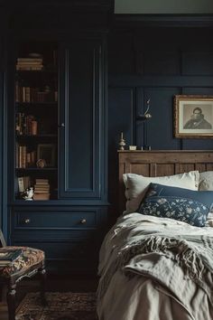 a bedroom with dark blue walls and white bedding