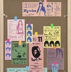 a bulletin board that has various concert tickets pinned to it