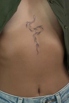 a woman's stomach with a tattoo on it