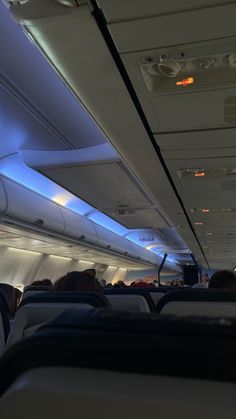 the interior of an airplane with blue lights