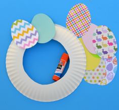 a paper plate wreath with some crafting supplies on it