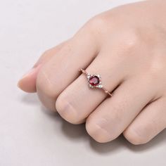 This is 5mm round cut natural garnet engagement ring rose gold. The accent stones are VVS man made cz diamond. The stones can be replace with other gemstones.For example,if you don't like the CZ accent,you can ask me replace it with tourmaline,aquamarine,diamond,emerald,sapphire... For custom making jewelry,it can be made in 2 different metal(Please contact me if you need this one made in solid gold). 1,Solid gold,including 14/18k white/rose/yellow gold. 2,925 sterling silver with white/yellow/r Ruby Ring With Rose Cut Diamonds And Cubic Zirconia, Elegant Round Garnet Crystal Ring, Rose Gold Birthstone Ring With Rose Cut Diamonds, Elegant Garnet Crystal Round Ring, Garnet Diamond Ring For Promise, Ruby Promise Ring With Rose Cut Diamonds, Round Garnet Diamond Ring With Prong Setting, Rose Gold Diamond Ring With Accent Stones, Garnet Ruby Ring For Promise