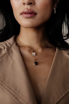 This elegant Calypso pendant necklace is a statement piece crafted with a luxurious CZ black diamond that is perfect for layering. The necklace is water and tarnish resistant, allowing you to confidently wear it daily. Show off your style with this precious and beautiful necklace. MATERIAL: 18k PVD Gold plated, CZ LENGTH: 18" COLOR: White or Black Water resistant, tarnish resistant, hypoallergenic, & nickel/lead free. Luxury Gold Plated Tarnish Resistant Diamond Necklace, Gold Diamond Pendant Necklace, Black Diamond Pendant, Black Agate Stone, Black Diamond Necklace, Black Water, Square Pendant, Diamond Pendant Necklace, Beautiful Necklace