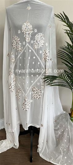 Fine georgette Chikankari Dupatta with hand embroidery and gota add ons with crochet lace. Luxury Off-white Lace Dupatta, Luxury Jamawar Dupatta With Chikankari Embroidery, Luxury Chikankari Embroidery Party Dupatta, Bohemian Resham Embroidered Georgette Fabric, White Anarkali Set With Handwork, Embroidered Lace Dupatta For Navratri, Festive Bohemian Sets With Cutwork, White Embroidered Fabric With Lace Work For Eid, White Handwork Dupatta For Wedding