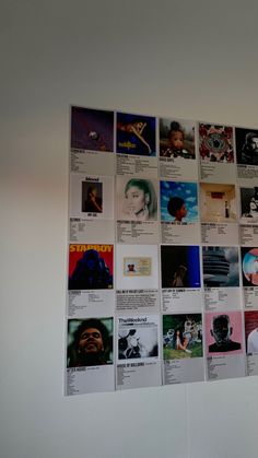 the wall is covered with many different pictures and posters, including one of them being an album