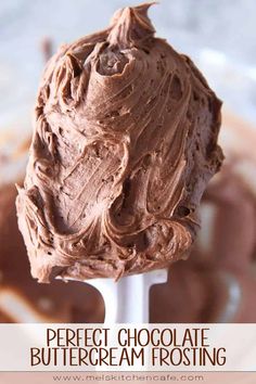 a spoon full of chocolate frosting in a bowl