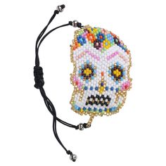 Placing a sugar skull in your home will bring you good fortune.  The traditional sugar skull plays an important role in celebrating the life of deceased loved ones. Hand beaded with love by our talented artisans, a portion of the proceeds from this collection will be donated to empower women and alleviate poverty in Guatemala.  Your purchase makes a difference! Halloween Skull Print Bracelet Gift, Adjustable Skull Bracelet As Gift, Adjustable Skull Bracelets As Gift, Adjustable Skull Print Bracelet As Gift, Adjustable Handmade Skull Bracelets, Handmade Bohemian Bracelets For Halloween, Bohemian Handmade Bracelets For Halloween, White Skull Jewelry For Day Of The Dead, Handmade Skull Bracelet As A Gift