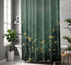 a green shower curtain with yellow flowers on it