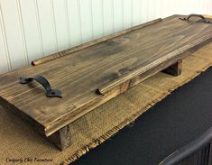 a wooden bench sitting on top of a rug