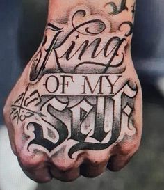 a man's hand with the words king of my soul tattooed on it, in black ink