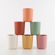 six different colored cups stacked on top of each other