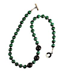 This is part of Chairish’s Costume Jewelry assortment.  Immerse yourself in timeless elegance with this magnificent 20-inch Malachite necklace, a true statement of luxury and sophistication. The necklace features 10mm smooth Malachite beads, renowned for their vivid green hues and signature banded patterns, expertly separated by sparkling faceted black Spinel accents that add a dazzling touch. Highlighting the design are three striking 15mm smooth black Onyx beads, positioned as bold focal point Elegant Green Beaded Necklaces With Black Beads, Elegant Single Strand Malachite Jewelry, Elegant Malachite Gemstone Beads Jewelry, 20 Inch Necklace, Malachite Necklace, Green Hues, Hammered Sterling Silver, Onyx Bead, Black Spinel