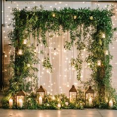 candles and greenery decorate the backdrop for an outdoor ceremony