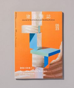 an orange and blue book with chinese writing on it's cover, sitting on a gray surface