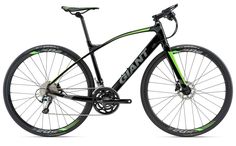 a black and green bike is shown against a white background with the words giant written on it