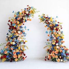 two archways made out of flowers and butterflies