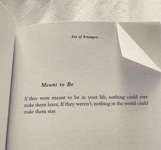 an open book with a piece of paper sticking out of it's center and the words meant to be