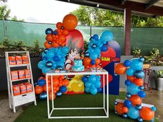 balloons and decorations are on display at an outdoor birthday party in the shape of cartoons