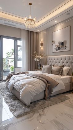 a large bed sitting in the middle of a bedroom next to a tall glass window