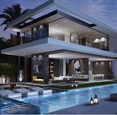 a large modern house with a pool at night