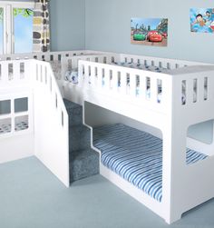 a child's bedroom with bunk beds, stairs and pictures on the wall above them