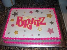 a birthday cake with the word braz on it, surrounded by stars and sparkles