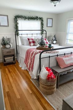 a bedroom decorated for christmas with red and white decor