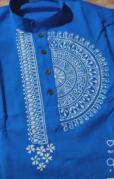 a blue shirt with white designs on it