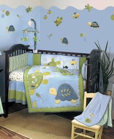 a child's room with blue walls and green bedspreads, including a crib