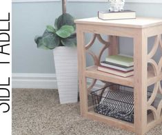 a small wooden shelf with books on top and a plant in the corner next to it