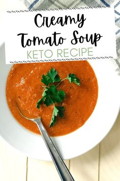 a bowl of creamy tomato soup with a spoon in it and a sign that says creamy tomato soup