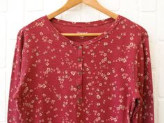 Cozy burgundy floral long sleeve top by Seg'ments. 100% cotton. Condition: Excellent, like new condition.  Fibre Content: 100% cotton Size/Fit: Tag size is women's large. Could fit women's medium (relaxed fit) or large. Shirt is about/just below hip length. Cotton jersey fabric has some stretch. Please see measurements below. Compare measurements to your own clothing to get an idea of fit. Measurements are taken in inches with the garment lying flat: shoulder seam to shoulder seam - 16.5" should Burgundy Shirt, Long Sleeve Floral Top, Cotton Jersey Fabric, Burgundy Floral, Hip Length, Jersey Fabric, Womens Clothing Tops, Pink Flowers, Vintage Outfits