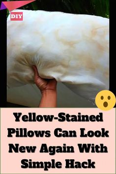 a person holding a pillow with the words yellow - stained pillows can look new again with simple hacks