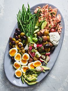 a plate filled with different types of vegetables and eggs on top of eachother