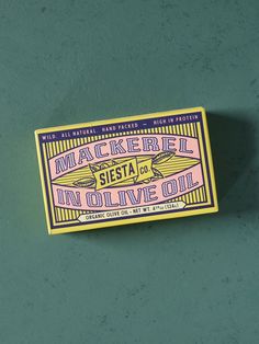 a sticker on the side of a wall that says mackerel siesta in olive oil