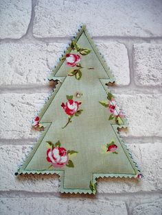 a christmas tree made out of fabric on a brick wall