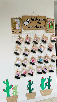 a bulletin board with pictures and cactuses hanging on it's sides, in front of a welcome to our class sign