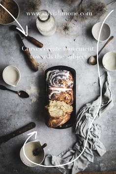 a loaf of bread sitting on top of a table next to bowls and utensils