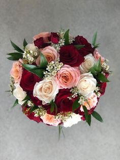 a bridal bouquet with roses and baby's breath