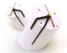 two clocks made to look like faces with black hands