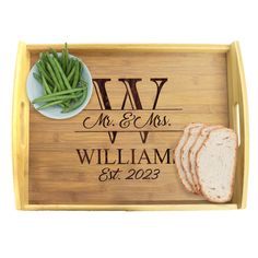 a personalized bamboo serving tray with bread and green beans on the side for a wedding gift