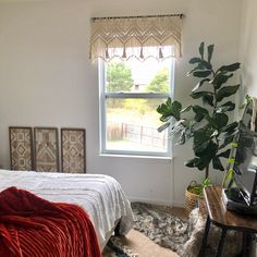 a bedroom with a bed, window and rug