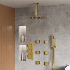 a modern bathroom with gold fixtures on the wall and tile flooring, including a shower head