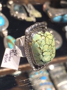 "Native American Indian made Tibetan green turquoise matrix sterling silver ring... with polished alternating frame composed of pressed sterling silver balls, small and large, giving a flowing energy to the design. size 7-7.5 1 1/4\" x 7/8\" total 7/8\" x 5/8\" x 1/4\" stone 54R - This stunning piece is coming from an exciting new relationship with a well known & popular Santa Fe, NM, jewelry gallery. I will be listing many exquisite, even World Class, pieces in the near future, most at lowe Unique Green Polished Turquoise Ring, Unique Green Turquoise Ring With Polished Finish, Elegant Green Turquoise Ring, Artisan Green Turquoise Sterling Silver Ring, Elegant Green Turquoise Ring Stamped 925, Jewelry Gallery, New Relationship, Stamped Rings, Santa Fe Nm